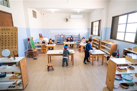 Sala Montessori preparada com crianças trabalhando