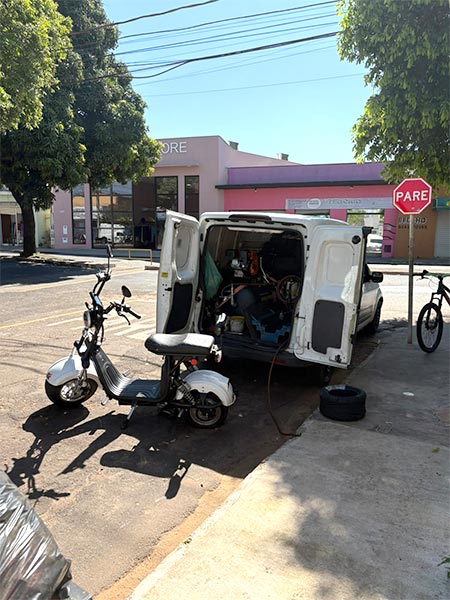 Serviço de borracharia móvel Veículo de borracharia móvel ao lado de uma motocicleta